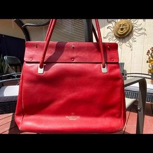 Elegant Authentic Valentino Garavani shoulder bag in red leather.